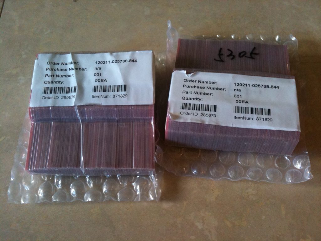 Shrink-wrapped red PCBs